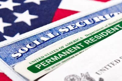 What do you call a person who has been granted authorization to live and work in the United States on a permanent basis, but is not eligible for certain benefits, such as voting and some social services?